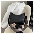 Detail of glossy black shoulder bag featuring adjustable wide geometric woven strap - Black