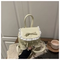 Dettaglio mini zaino in pelle bianca con bordo in pizzo e fiocco decorativo - Beige