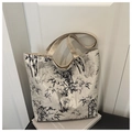Detailed view of ink bamboo print on a beige canvas tote bag with woven strap - Off White