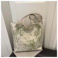 Close-up of bamboo print tote bag with woven handles on minimalist background - Green
