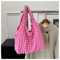 Detail of pink bubble texture fabric on a stylish shoulder tote bag hanging indoors - Rose Pink