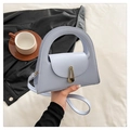 Light blue mini leather handbag with unique arched handle and golden geometric lock - Blue