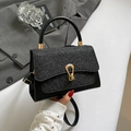 Chic black glitter crossbody bag with gold horseshoe clasp and sleek top handle - Black