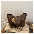 Close-up of deep brown tote bag featuring decorative silk scarf on a soft surface - Brown