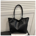 Detail of woven leather texture and knotted handle on black luxury commute tote bag - Zipper Closure Style (Black) / Black