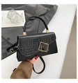 Detail of black faux crocodile skin handbag with elegant gold geometric metal clasp - Black