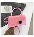 Detail of pink crocodile embossed leather bag with gold geometric metal lock clasp - Pink