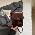 Retro brown leather vertical crossbody phone bag with FASHION logo and metallic charm - Brown