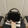 Chic black crescent saddle bag with gold trim and long shoulder strap for women - Black