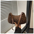 Close-up of leopard print baguette bag with brown leather strap and metal ring detail - Leopard Brown