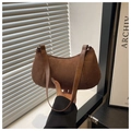 Detail of a brown crescent shoulder bag in textured faux suede with smooth leather strap - Brown