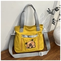 Detail of yellow nylon tote bag with cute capybara print and silver reflective webbing - Yellow