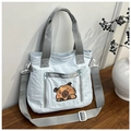 Close-up of light blue nylon tote bag with cute cartoon panda and adjustable strap - Blue