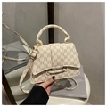 Detail view of cream textured leather handbag with brown M pattern and gold hardware - Rick Morty McDonald White