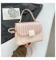 Detail of pink faux leather handbag featuring crocodile texture flap and square clasp - White