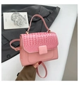 Detail of light pink crocodile texture flap and smooth body on high-end handbag - Pink