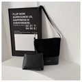 Detail of black large bucket bag with matching small pouch and gold stamped fashion logo - Black