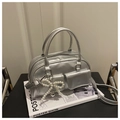 Detailed view of silver metallic Boston bag with pearl bow charm and dual front pockets - Silver