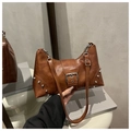 Close-up of brown PU leather tote bag with silver rivets and decorative buckle detail - Brown