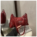 Close-up of red Y2K rivet tote bag featuring silver studs and metallic buckle detail - Red