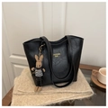 Detail of black faux leather tote with gold logo and houndstooth bunny charm - With Charm / Black