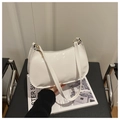Chic white patent leather shoulder bag with a glossy finish and crescent moon shape - White