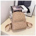 Detail of apricot mini backpack with V-shaped quilting and golden M letter metal logo - Khaki