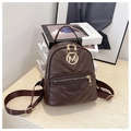 Detail of dark brown quilted faux leather backpack with golden M hardware and zippers - Brown