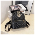 Close-up of V-quilted black leather mini backpack with golden metal M logo and zippers - Black