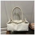 Close-up of off-white corduroy tote bag featuring a buckle strap and textured fabric detail - White