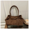 Close-up of brown corduroy tote bag with leather straps and metal buckle detailing - Coffee