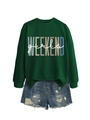 Flat lay of green WEEKEND girls sweatshirt paired with distressed denim shorts - Dark Green with White Print