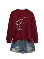 Detail of burgundy sweatshirt featuring a creative dandelion book print and ripped denim shorts - S / Burgundy