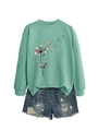 Flat lay of mint green long-sleeved sweatshirt with dandelion book print and denim shorts - S / Light Green