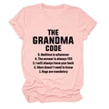 Detail of pink cotton t-shirt featuring THE GRANDMA CODE graphic print on flat lay - Pink (Black Text)