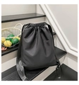 Detail of black drawstring backpack with matte synthetic fabric and wide woven straps - Black