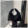 Detail of black faux shearling dumpling bag with leather strap and plush handle - Black Large