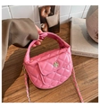 Close-up of pink quilted leather mini bag featuring a floral silver metal clasp - Deep Pink