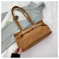 Detailed macro view of brown suede underarm bag with metal buckle on denim background - Brown