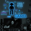 Lichtgevende gaming muursticker set met gloeiende gamer silhouetten en spelpictogrammen - Blauw