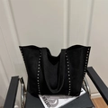 Black matte tote bag with silver studs on a modern armchair, stylish large capacity design - Black