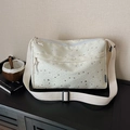 Cream canvas crossbody bag with silver star patterns and adjustable wide strap - Off White