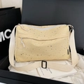 Yellow canvas shoulder bag with silver star patterns and adjustable woven strap - Beige