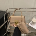 Khaki square handbag with matching mini pouch and gold buckle, shown in lifestyle setting - Without Mini Bag / Khaki