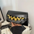 Chic black patent leather crossbody bag with oversized gold wavy metal handle for women - Black