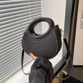 Detail of black glitter pleated crescent bag with circular handle and gold hardware - Black
