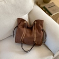 Vintage brown suede tote bag with gold chain strap on a sofa for casual commute style - Brown