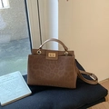 Detail of leopard print crossbody bag featuring gold metal twist lock and faux leather texture - Brown