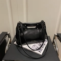 Minimalist black faux leather tote bag with circular handle and gold stud accents - Black