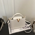 White faux leather crossbody bag with golden V hardware and adjustable shoulder strap - Off White